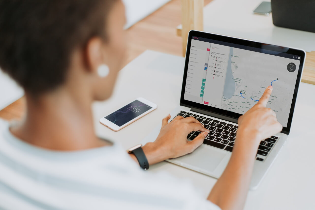 Woman using schedules on guud software on laptop